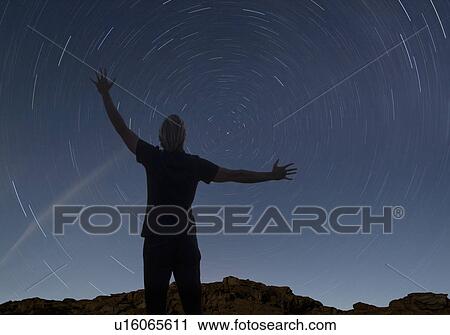 man watching the starry night sky View Large Photo Image Stock Image - man watching the starry night sky. Fotosearch