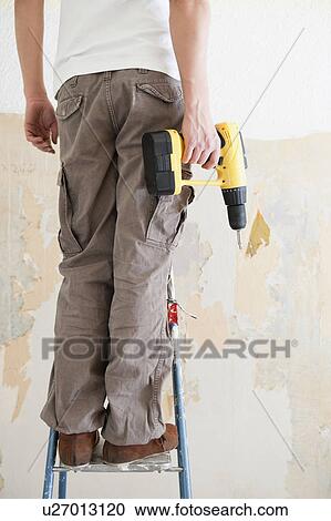 Man with electric screwdriver View Large Photo Image Stock Image - Man with electric screwdriver. Fotosearch