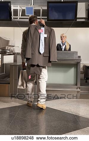 Man with new suit at the airport View Large Photo Image Stock Photo - Man with new suit at the airport. Fotosearch