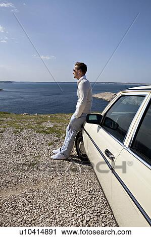 Man with oldtimer overlooking sea View Large Photo Image Stock Image - Man with oldtimer overlooking sea. Fotosearch