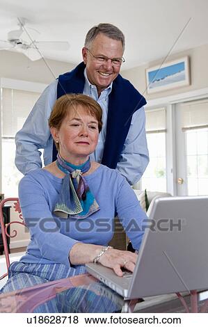 Stock Photo - Mature couple working on computer. Fotosearch