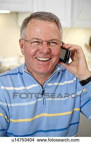Picture - Mature man talking on cell phone. Fotosearch
