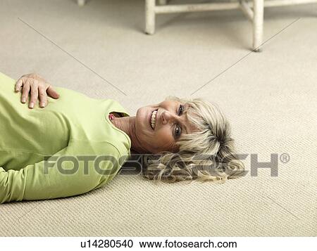 Mature pregnant woman lying on floor View Large Photo Image Stock Image - Mature pregnant woman lying on floor. Fotosearch
