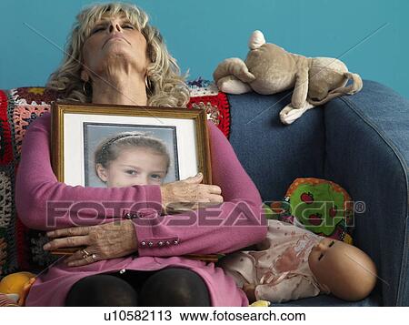 Mature woman asleep with childs picture View Large Photo Image Stock Image - Mature woman asleep with childs picture. Fotosearch
