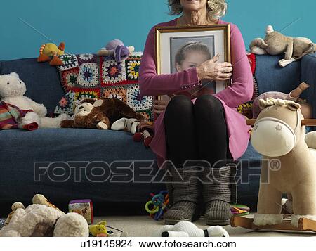 Mature woman holding picture of child View Large Photo Image Picture - Mature woman holding picture of child. Fotosearch