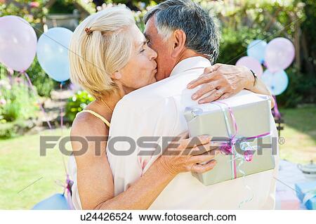mature woman kisses mature man. View Large Photo Image Picture - mature woman kisses mature man. . Fotosearch
