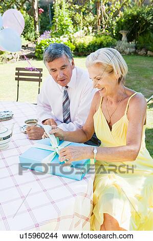 mature woman opening present. View Large Photo Image Picture - mature woman opening present.. Fotosearch