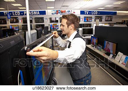 Stock Photo - Measuring out a large-sized flatscreen. Fotosearch