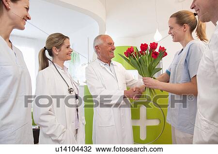 Stock Image - Medical team thanking doctor. Fotosearch