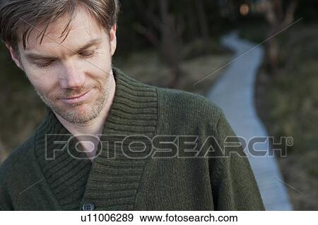 Stock Photo - Men portrait in nature background. Fotosearch
