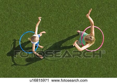 Stock Image - Mother and child playing in a garden. Fotosearch