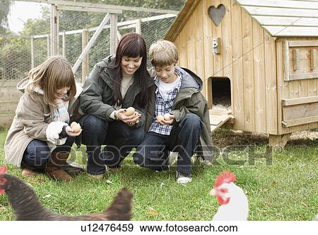 Mother and children feeding chickens View Large Photo Image Stock Photo - Mother and children feeding chickens. Fotosearch