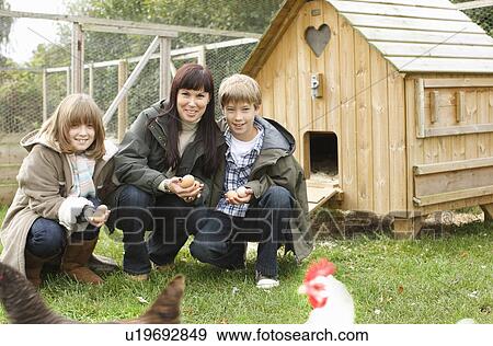 Mother and children feeding chickens View Large Photo Image Stock Photo - Mother and children feeding chickens. Fotosearch
