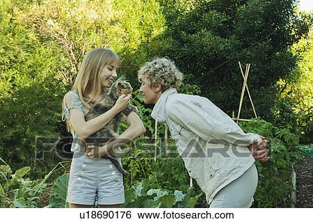 Mother and daughter and cat in garden View Large Photo Image Stock Photograph - Mother and daughter and cat in garden. Fotosearch