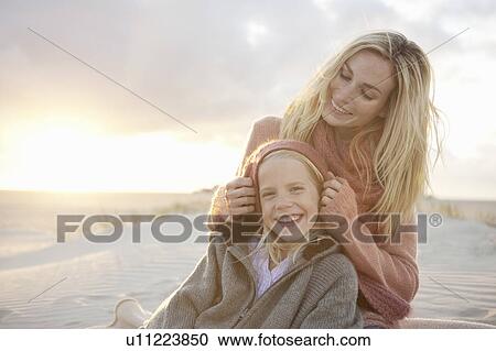 Stock Image - Mother and daughter on beach. Fotosearch