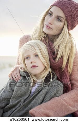 Stock Image - Mother and daughter on beach. Fotosearch