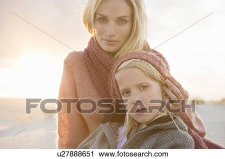 Stock Image - Mother and daughter on beach. Fotosearch