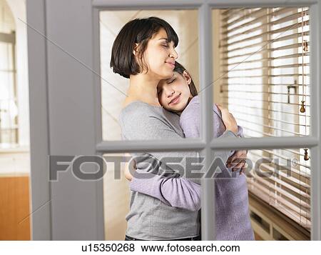 Stock Photo - Mother and daughter snuggling. Fotosearch