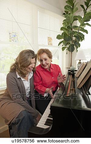 Mother and daughter talking at piano View Large Photo Image Stock Photograph - Mother and daughter talking at piano. Fotosearch