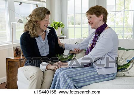 Stock Photo - Mother and daughter talking on coach. Fotosearch