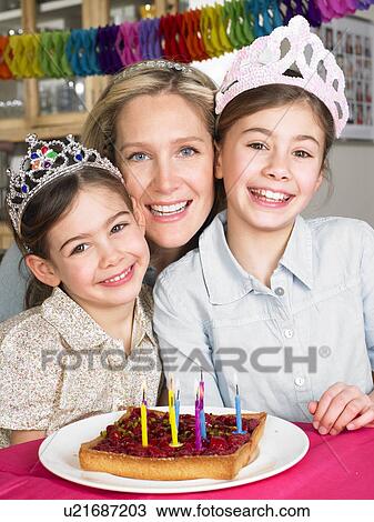 Stock Image - Mother and daughters celebrating. Fotosearch