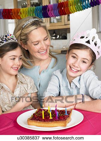 Mother and daughters celebrating View Large Photo Image Stock Photo - Mother and daughters celebrating. Fotosearch