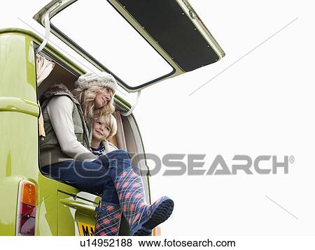 Stock Photo - Mother and son at back of camper van. Fotosearch
