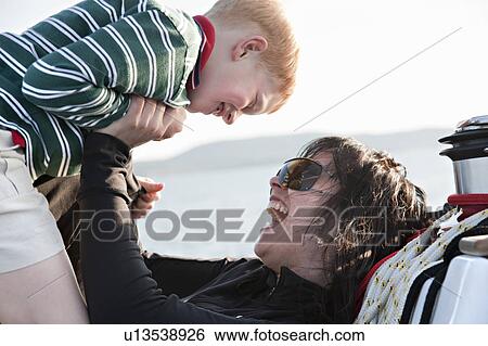 Mother and son playing on yacht View Large Photo Image Stock Photograph - Mother and son playing on yacht. Fotosearch