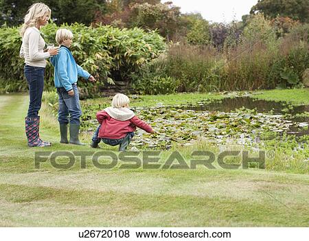 Stock Photo - Mother and sons near pond . Fotosearch