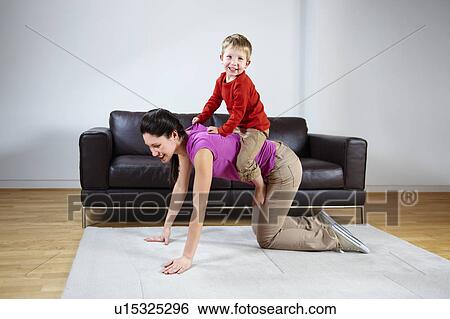 Mother giving boy a piggyback ride View Large Photo Image Stock Photograph - Mother giving boy a piggyback ride. Fotosearch