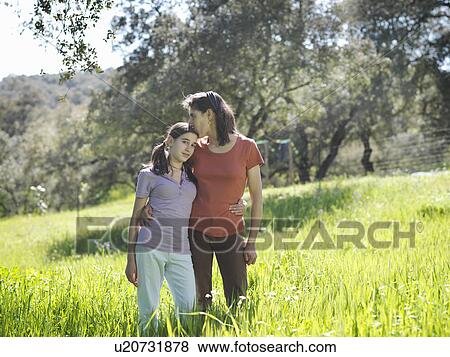 Mother kissing on forehead daughter View Large Photo Image Stock Photo - Mother kissing on forehead daughter. Fotosearch