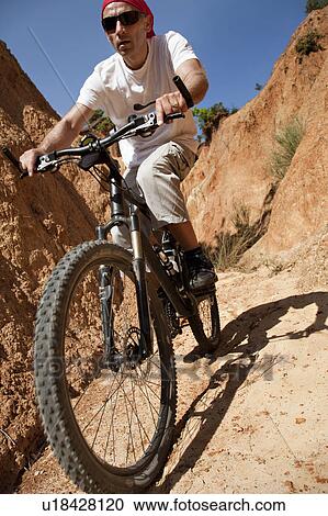 Stock Image - Mountainbiker in canyon. Fotosearch