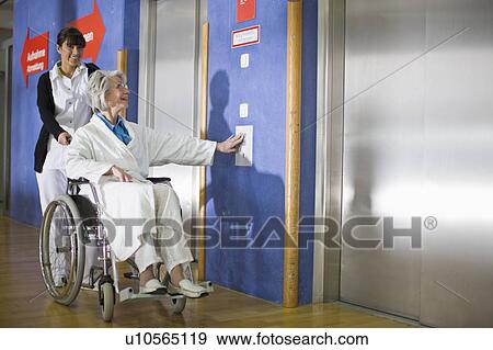Stock Photo - Old woman in a wheel chair and nurse. Fotosearch