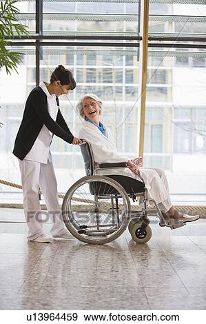 Old woman in a wheel chair and nurse View Large Photo Image Stock Photo - Old woman in a wheel chair and nurse. Fotosearch