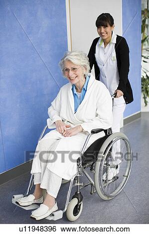 Old woman in a wheel chair and nurse View Large Photo Image Stock Photograph - Old woman in a wheel chair and nurse. Fotosearch