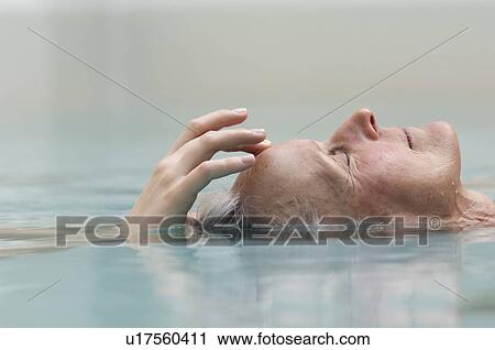 Older woman meditating in pool View Large Photo Image Stock Image - Older woman meditating in pool. Fotosearch