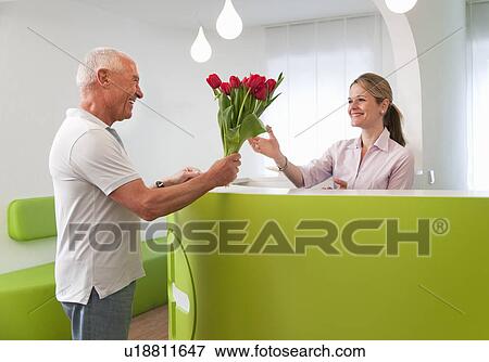 Patient thanking receptionist View Large Photo Image Stock Photo - Patient thanking receptionist. Fotosearch