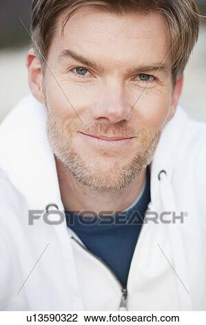 Portrait of a man in white hoodie View Large Photo Image Stock Image - Portrait of a man in white hoodie. Fotosearch