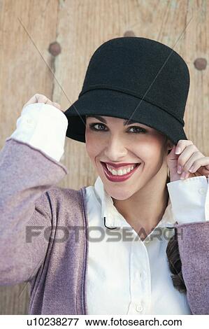 Portrait of a woman wearing a hat View Large Photo Image Stock Photo - Portrait of a woman wearing a hat. Fotosearch