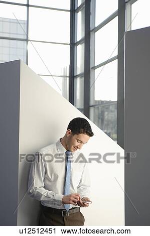 Portrait of businessman checking mobile View Large Photo Image Stock Image - Portrait of businessman checking mobile. Fotosearch