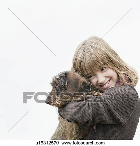 Portrait of girl embracing dog in arms View Large Photo Image Stock Image - Portrait of girl embracing dog in arms. Fotosearch