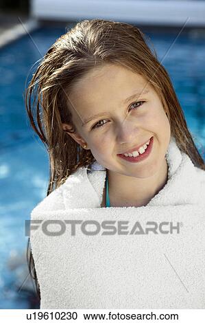 Stock Image - Portrait of girl wrapped in towel. Fotosearch