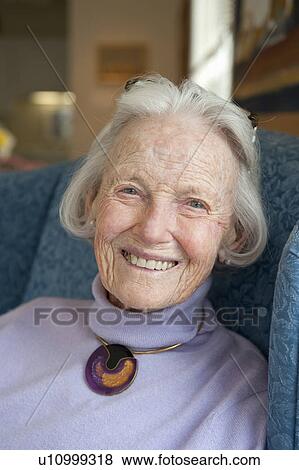 Stock Photo - Portrait of senior sitting in chair. Fotosearch