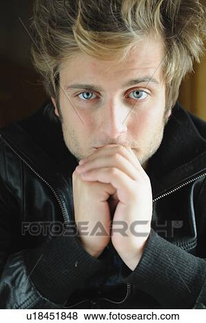 Stock Photo - Portrait of serious young man. Fotosearch