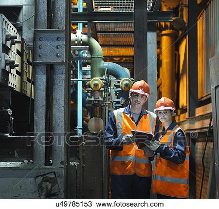 Stock Image - Portrait Of Steel Engineers In Factory. Fotosearch