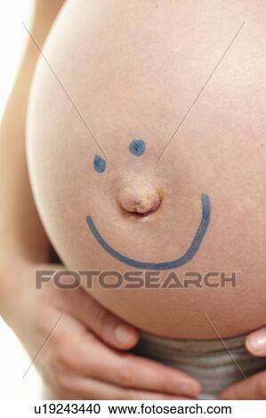 Pregnant belly with smiley face View Large Photo Image Stock Image - Pregnant belly with smiley face. Fotosearch
