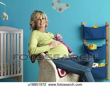 Pregnant mature woman knitting View Large Photo Image Stock Image - Pregnant mature woman knitting. Fotosearch