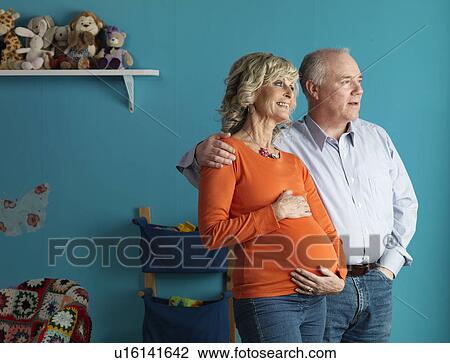 Stock Image - Pregnant older woman with male partner. Fotosearch