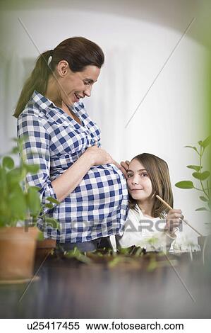 Pregnant woman and little girl View Large Photo Image Stock Photography - Pregnant woman and little girl. Fotosearch