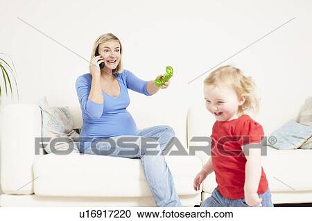 Pregnant woman on phone with toddler View Large Photo Image Stock Image - Pregnant woman on phone with toddler. Fotosearch